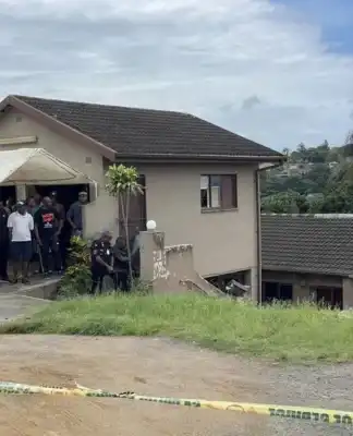 One shot and three held hostage in their home.