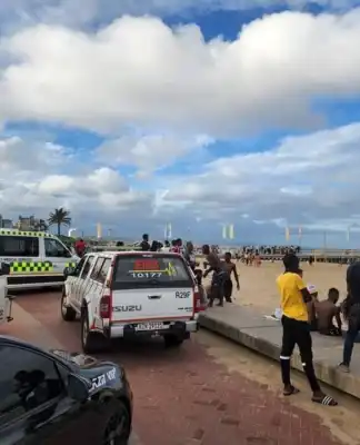 Three dead after freak wave sweeps beach goers against pier at Durban North Beach.